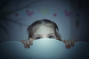 scared little girl in her bed